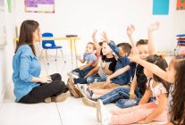 profile view group preschool students raising their hands trying participate school min 1024x683